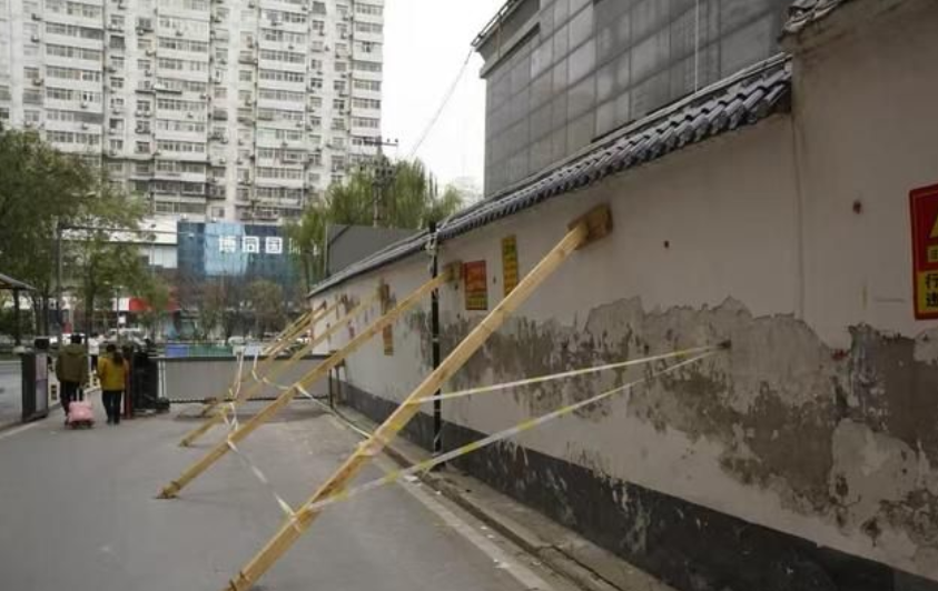 西安一小区墙体倾斜用6根木材支撑很危险 邻居两物业为了一堵墙闹上法庭